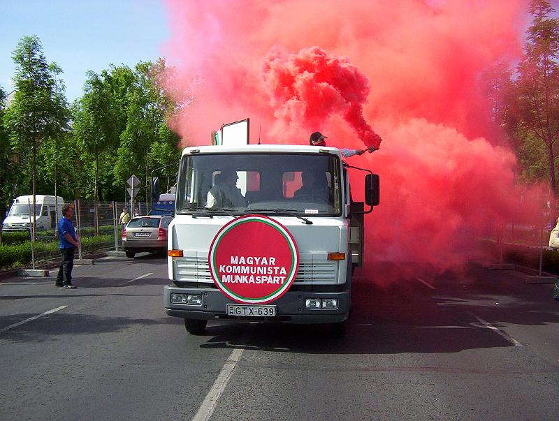 100_1701.jpg - Red smoke signals the arrival of the Hungarian Communist Workers' Party. Notice that the party's logo--as seen on the front of the vehicle--is a red circle, rather than the customary red star. Red stars, along with swastikas, are banned by law in Hungary.