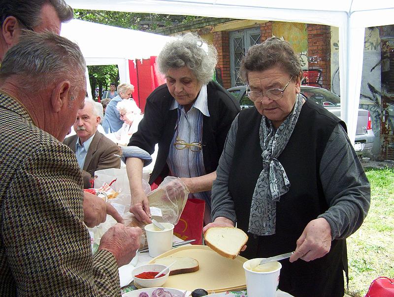 100_1713.jpg - The Communist ladies feed the crowds. They are spreading lard on bread.